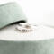 Sterling silver "I Am Charlie" tribute ring with cross, honoring Charlie Kirk, in a green velvet ring box with white flowers.
